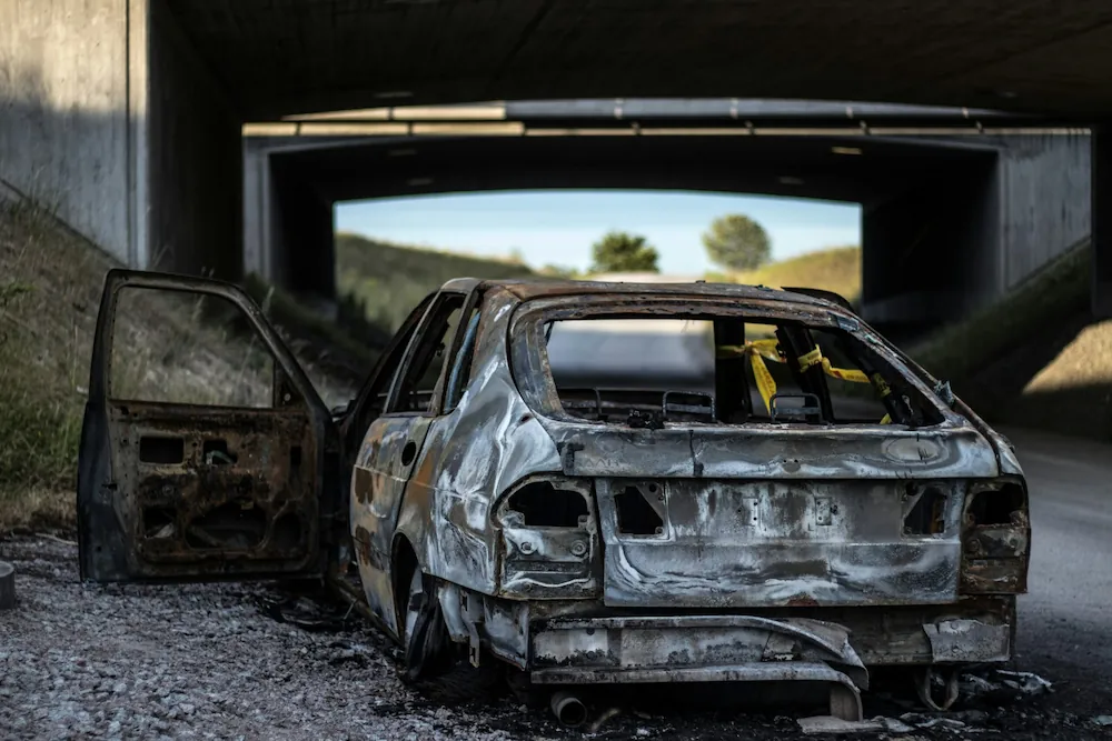 Home | Non-Fault Accident Claim & Vehicle Recovery London Burnt vehicle in repair garage representing post-accident repair service by SSS Claims UK.